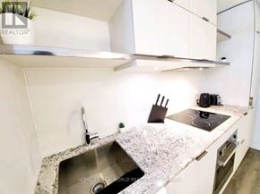 Toronto (Church-Yonge Corridor) condo for rent - A modern kitchen with a sink and a stove top.