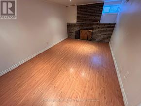 Toronto (Birchcliffe-Cliffside) apartment for rent - A room with wooden flooring and a brick wall.