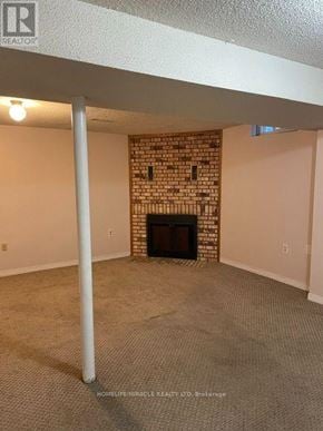 Mississauga (East Credit) apartment for rent - A room with a fireplace and a carpeted floor.