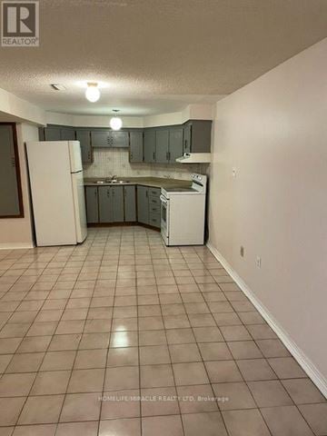 Mississauga (East Credit) apartment for rent - A kitchen with white appliances and a tile floor.