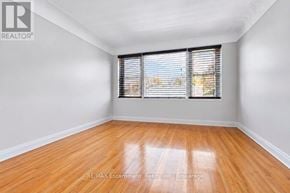 Burlington (Brant) multi-family for rent - A room with wooden flooring and a window with blinds.