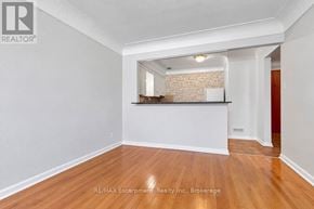Burlington (Brant) multi-family for rent - A room with a brick wall and wooden flooring.