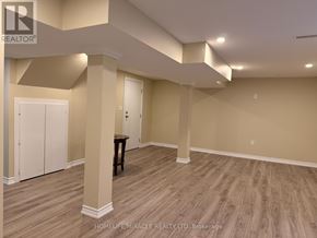 Brampton (Heart Lake West) apartment for rent - A spacious room with wooden flooring and white walls.