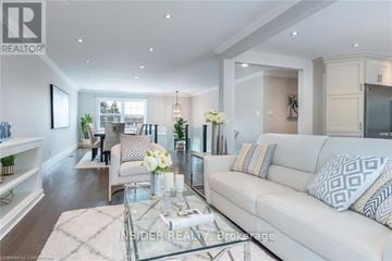 Waterloo apartment for rent - A well-lit, modern living room with a glass coffee table and a white sofa.