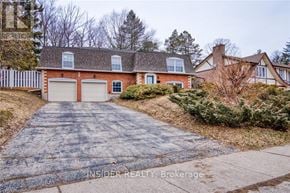 Waterloo apartment for rent - A house with a brick facade and a white garage door is for sale.