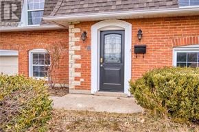 Waterloo apartment for rent - A brick house with a black door and a small window on the left.