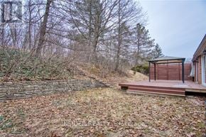 Waterloo apartment for rent - A small wooden cabin sits in a field with a deck in front.