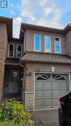 Mississauga (East Credit) townhouse for rent - House number 66 with a grey garage door.