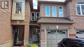 Mississauga (East Credit) townhouse for rent - A brick house with a black car parked in front.