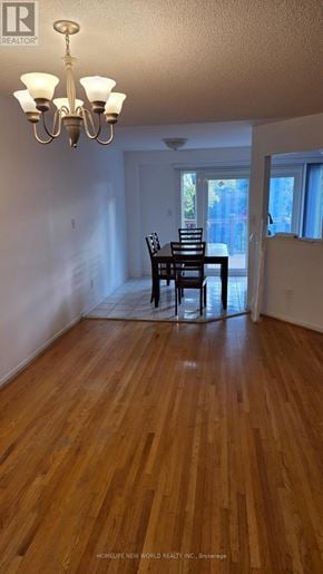 Mississauga (East Credit) townhouse for rent - A dining room with a wooden floor and a chandelier.