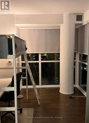 Toronto (Annex) condo for rent - A room with a ladder and a table.
