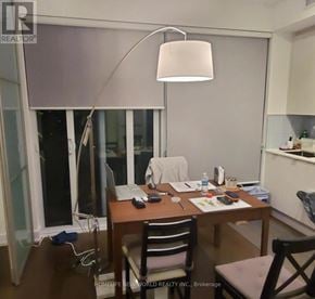 Toronto (Annex) condo for rent - A table with a laptop and a lamp on it.