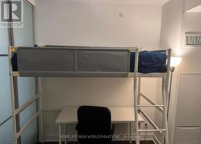 Toronto (Annex) condo for rent - A small room with a bunk bed and a desk.