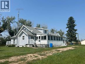 Rural Kneehill County apartment for rent - A house with a blue trash can in front of it.
