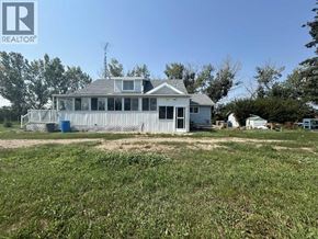 Rural Kneehill County apartment for rent - A house with a fence in front of it is for sale.