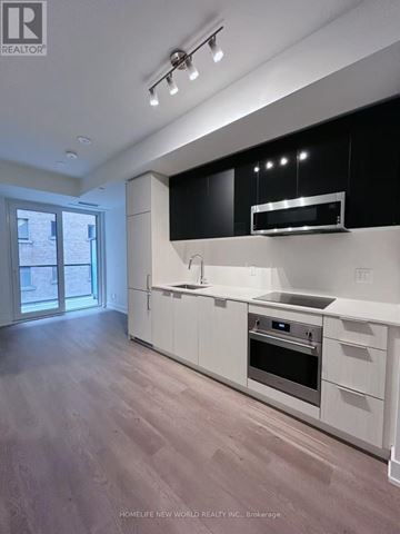 Toronto (Church-Yonge Corridor) condo for rent - A modern kitchen with white cabinets and stainless steel appliances.