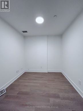 Toronto (Church-Yonge Corridor) condo for rent - A room with a wooden floor and white walls.