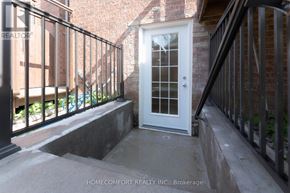 Richmond Hill (Jefferson) apartment for rent - A white door with a glass window is on the right side of a black railing.