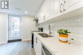 Richmond Hill (Jefferson) apartment for rent - A kitchen with white cabinets and a white countertop with a plant on it.