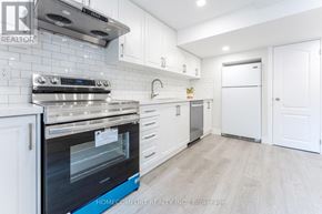 Richmond Hill (Jefferson) apartment for rent - A modern kitchen with white cabinets and a blue oven.