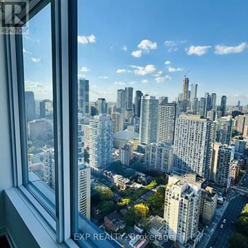Toronto (Moss Park) condo for rent - A cityscape is visible through a window.