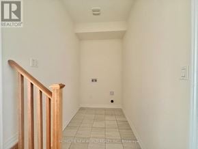 Pickering townhouse for rent - A hallway with a wooden railing on the left side.