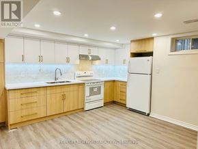 Markham (Raymerville) apartment for rent - A kitchen with wooden cabinets and a white refrigerator.