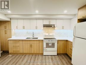 Markham (Raymerville) apartment for rent - A modern kitchen with wooden cabinets and appliances.