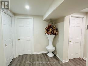 Markham (Raymerville) apartment for rent - A hallway with a vase of flowers on a pedestal in the middle.