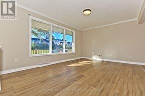 St. Catharines (Glendale/Glenridge) apartment for rent - A room with wooden floors and a large window.