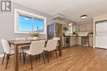 St. Catharines (Glendale/Glenridge) apartment for rent - A modern kitchen with a dining table and chairs.