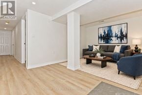 St. Catharines (Glendale/Glenridge) apartment for rent - A living room with a couch, a coffee table, and a painting on the wall.