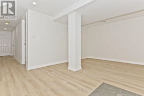 St. Catharines (Glendale/Glenridge) apartment for rent - A room with white walls and wooden flooring, with a doorway leading to another room.