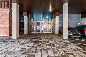 Kitchener condo for rent - A car is parked in front of a building with a glass door.
