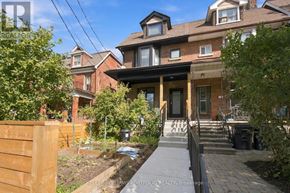 Toronto (Palmerston-Little Italy) duplex for rent - A house with a front yard and a fence.