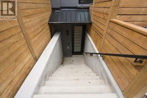 Toronto (Palmerston-Little Italy) duplex for rent - A staircase with wooden steps and railings leads to a dark room.