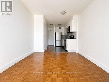 Toronto (Church-Yonge Corridor) condo for rent - A kitchen with white cabinets and a wooden floor.