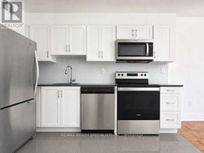 Toronto (Church-Yonge Corridor) condo for rent - A kitchen with white cabinets and stainless steel appliances.