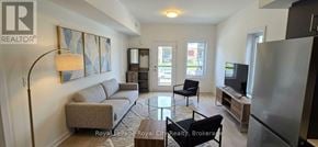 Guelph (Clairfields/Hanlon Business Park) townhouse for rent - A living room with a couch, chairs, and a television.