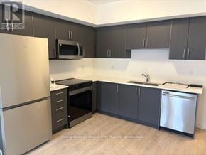 Guelph (Clairfields/Hanlon Business Park) townhouse for rent - A kitchen with a refrigerator, oven, and microwave.