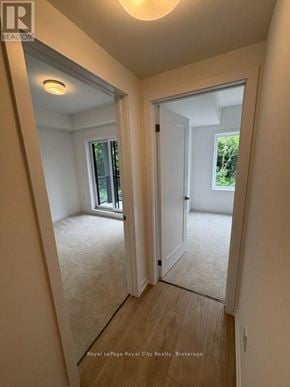Guelph (Clairfields/Hanlon Business Park) townhouse for rent - A room with a carpeted floor and a sliding glass door.