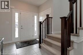 Cambridge apartment for rent - A staircase with a beige carpeted runner and wooden banister.