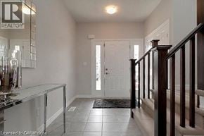 Cambridge apartment for rent - A hallway with a glass railing and a white door.
