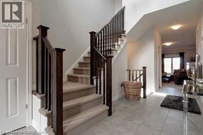 Cambridge apartment for rent - A staircase with a wooden handrail and a basket on the floor.