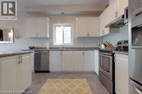 Cambridge apartment for rent - A kitchen with white cabinets and stainless steel appliances.