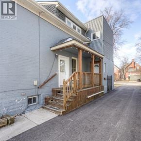 Kitchener apartment for rent - A house with a blue exterior and a wooden porch.