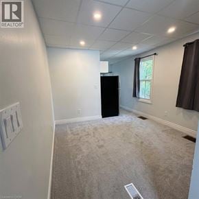 Kitchener apartment for rent - A room with a carpet floor and a window with curtains.