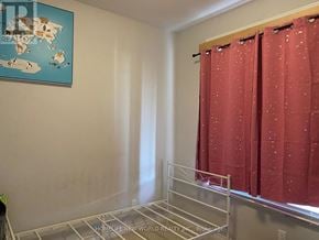 St. Catharines (Oakdale) townhouse for rent - A room with a red curtain and a world map on the wall.