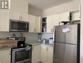 St. Catharines (Oakdale) townhouse for rent - A kitchen with a stove, oven, and refrigerator.