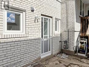 Toronto (Westminster-Branson) apartment for rent - A white brick house with a window and a door.